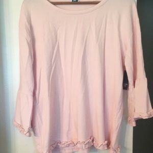 Pink top with ruffle detail.